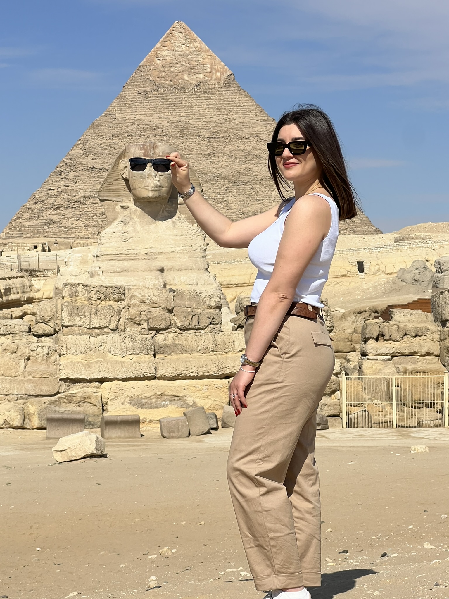 a girl taking picture with sphinx