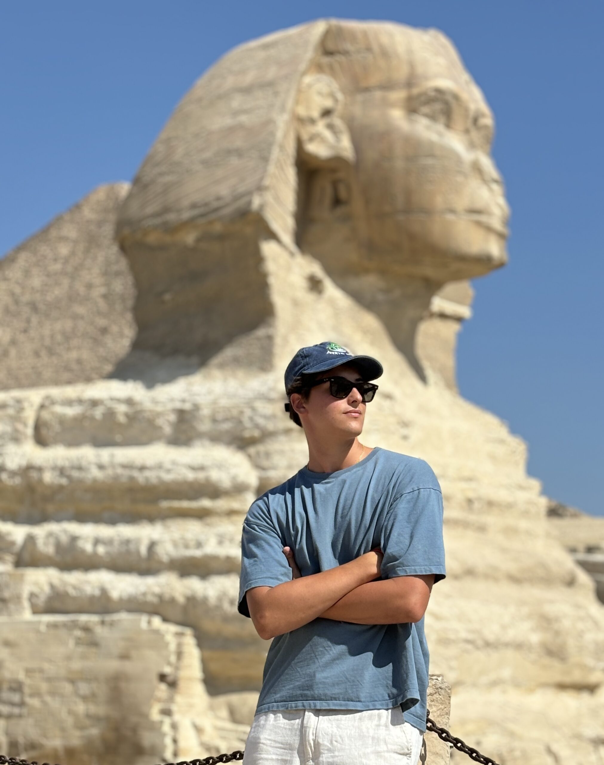 a person standing in front of sphinx