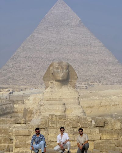 3 persons in front of sphinx